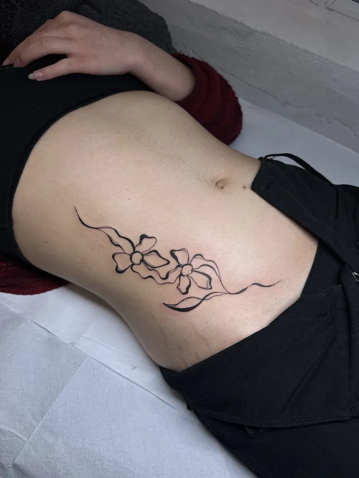 Florals and whip lines curving along the hip